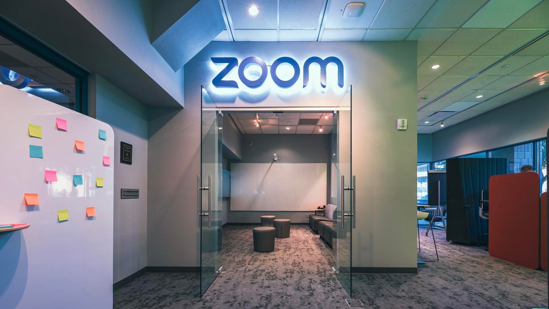 A room with two open doors and Zoom sign on top
